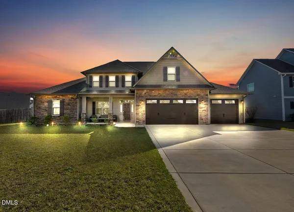 a front view of a house with a yard