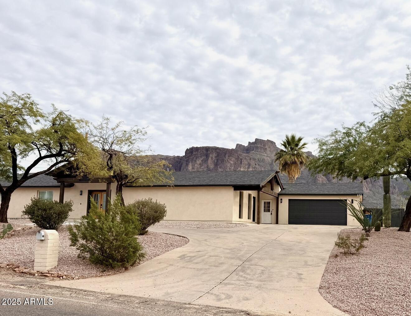 1165 North Mountain View Road Apache Junction, AZ 85119 - Photo 2 of 29 a house with green field in front of it