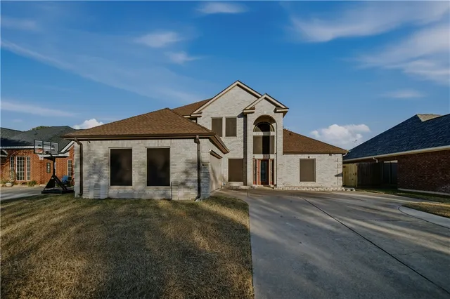a front view of a house with a yard