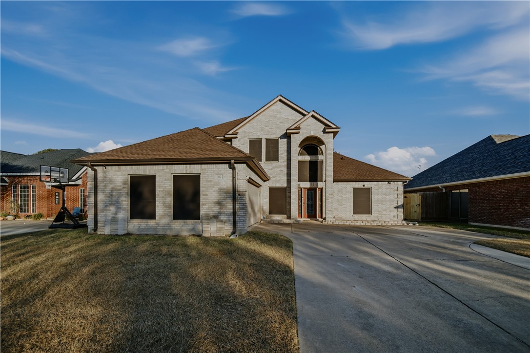 a front view of a house with a yard