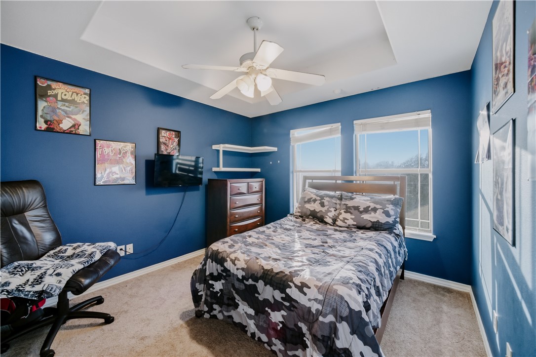 337 Wright Drive Portland, TX 78374 - Photo 18 of 30 a bedroom with a bed a couch and a chandelier