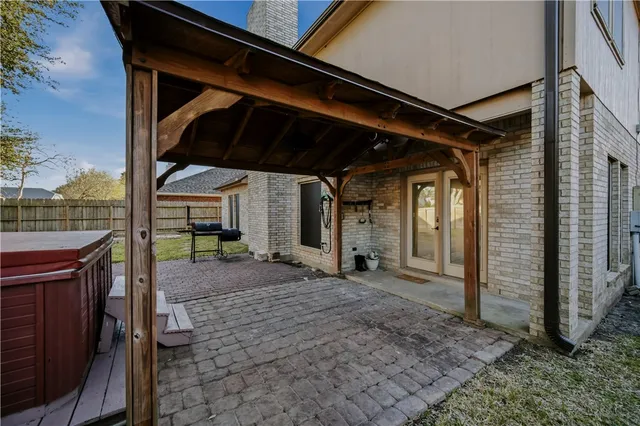 a view of a backyard with wooden fence