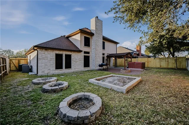 a view of a house with backyard tub and fire pit