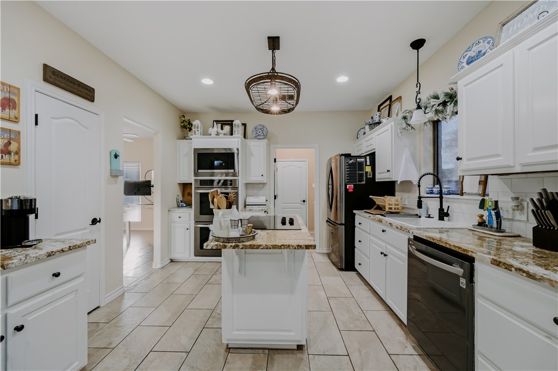 337 Wright Drive Portland, TX 78374 - Photo 7 of 30 a large white kitchen with stainless steel appliances granite countertop lots of counter top space
