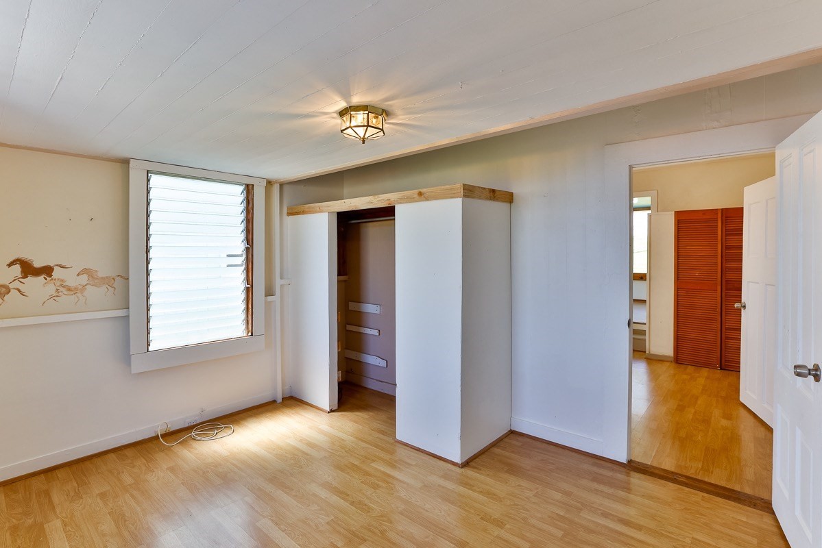 43-350 Pohakea Road, Unit 9 Paauilo, HI 96776 - Photo 11 of 28 a view of an empty room with window and wooden floor