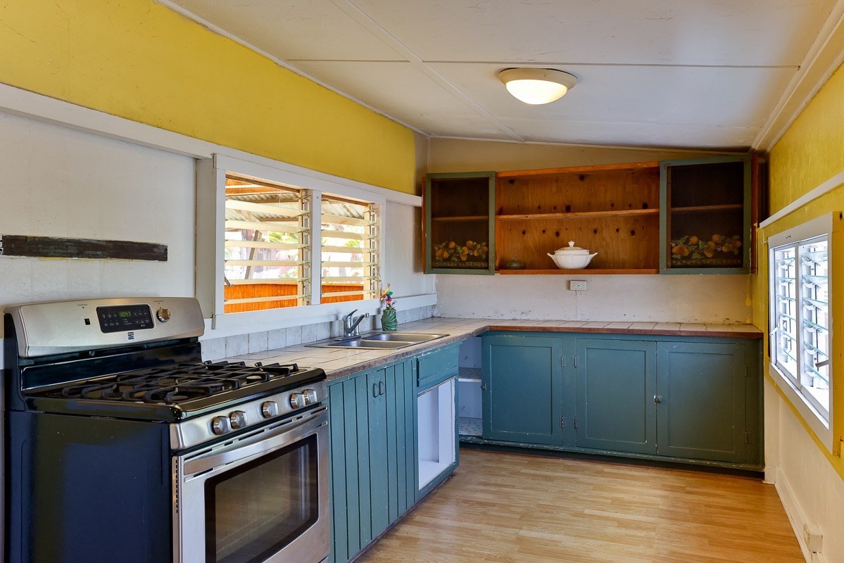 43-350 Pohakea Road, Unit 9 Paauilo, HI 96776 - Photo 18 of 28 a kitchen with a sink stove top oven and cabinets