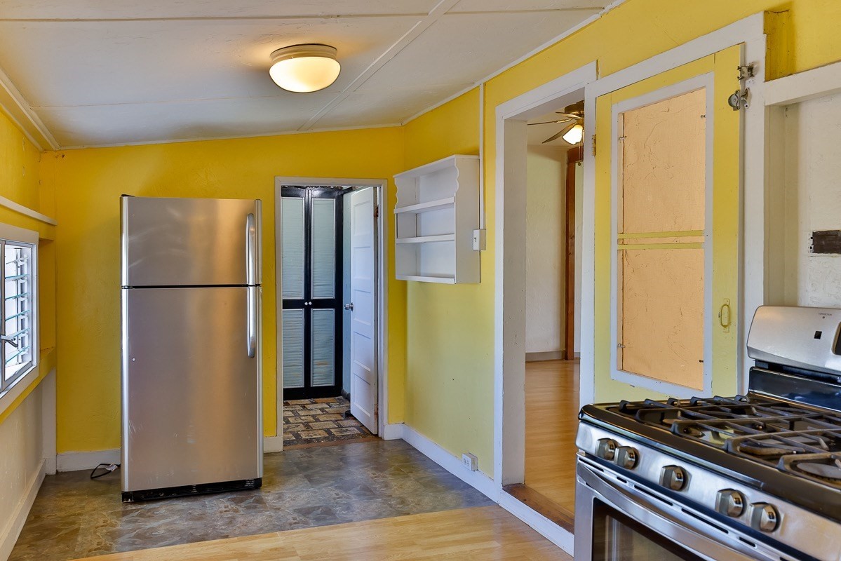 43-350 Pohakea Road, Unit 9 Paauilo, HI 96776 - Photo 19 of 28 a view of a kitchen with wooden floor and stainless steel appliances