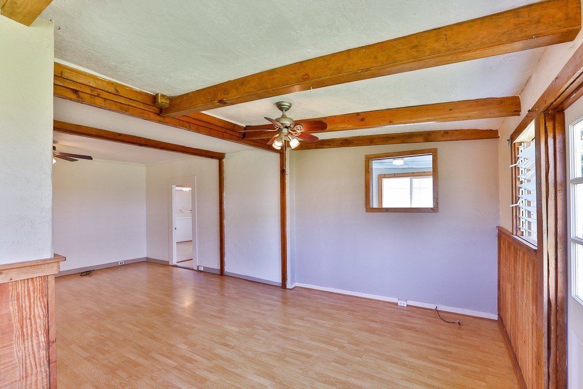 43-350 Pohakea Road, Unit 9 Paauilo, HI 96776 - Photo 5 of 28 an empty room with wooden floor and windows