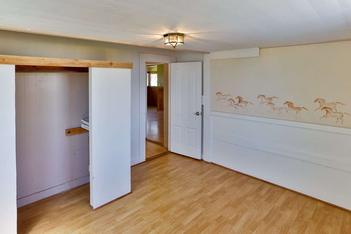 43-350 Pohakea Road, Unit 9 Paauilo, HI 96776 - Photo 9 of 28 a view of an empty room with closet and mirror
