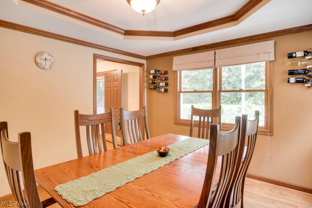 17450 Leggett Road Thompson, OH 44086 - Photo 12 of 21 Dining room with coffered ceiling and hardwood floors. Views across the front wrap around porch