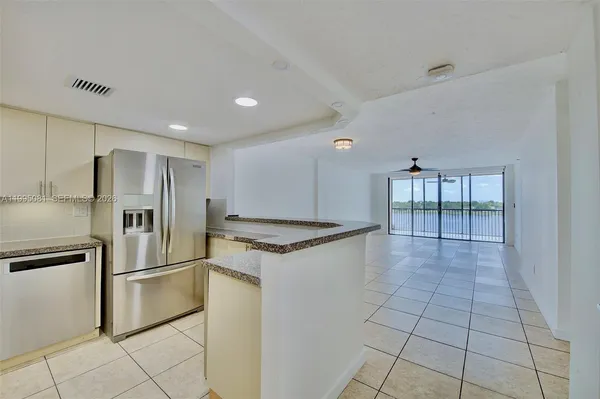 a kitchen with stainless steel appliances granite countertop a refrigerator and a stove