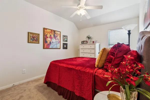 a living room with a bed and a chandelier