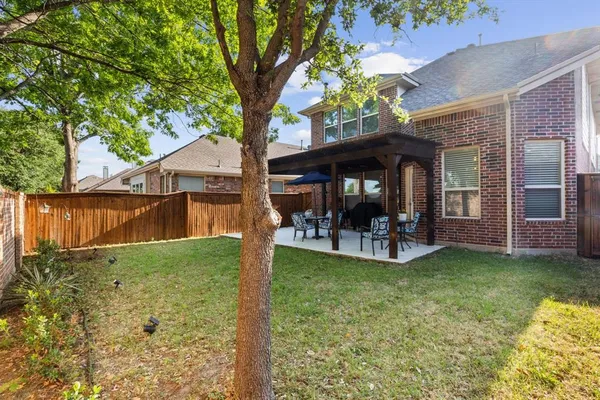 a view of a house with backyard porch and sitting area