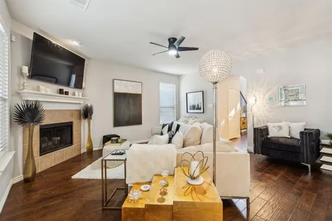 a living room with furniture a fireplace and a flat screen tv