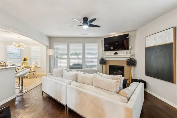 a living room with furniture a flat screen tv and a fireplace