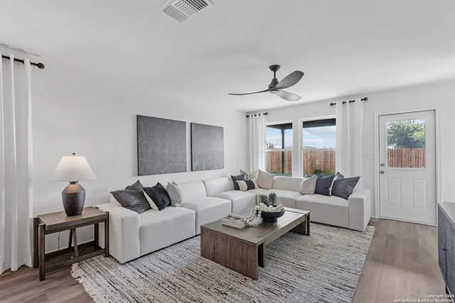 a living room with furniture and wooden floor