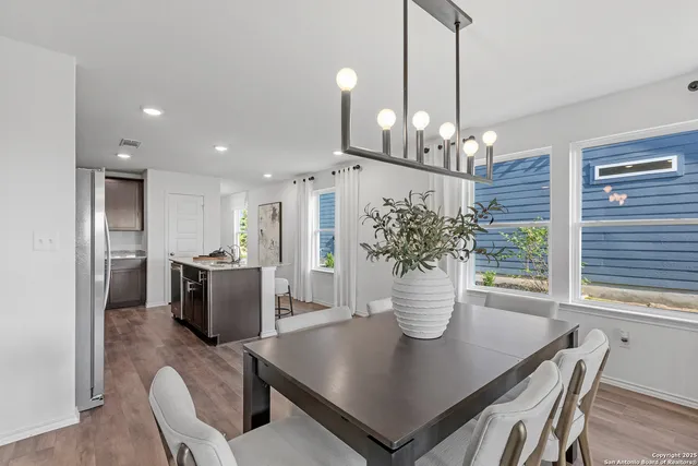 a view of a dining room with furniture and chandelier