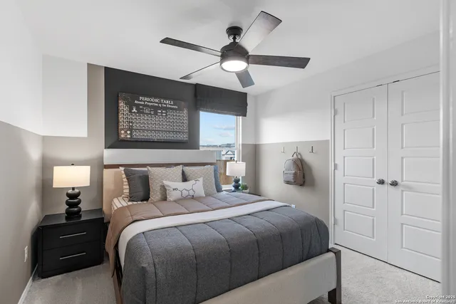 a bedroom with a bed and a lamp on the dresser