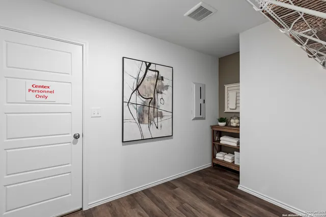a view of room with wooden floor and cabinet