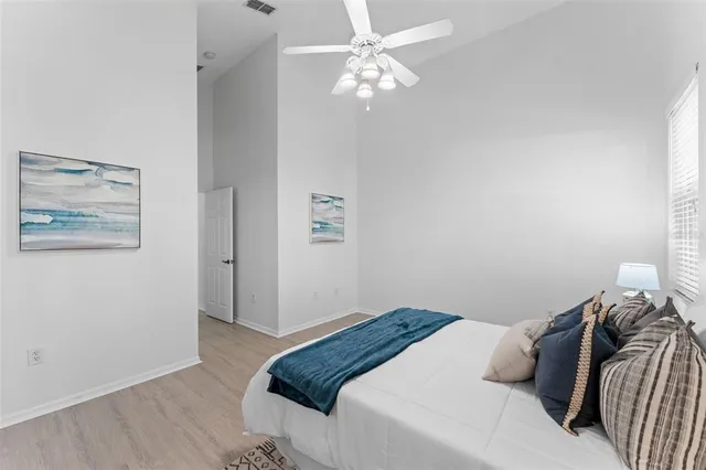 an empty room with a window and a fan