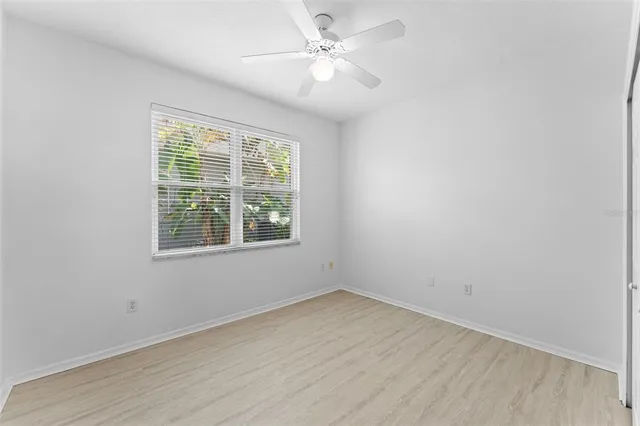 an aerial view of a city with lots of residential buildings ocean and mountain view in back
