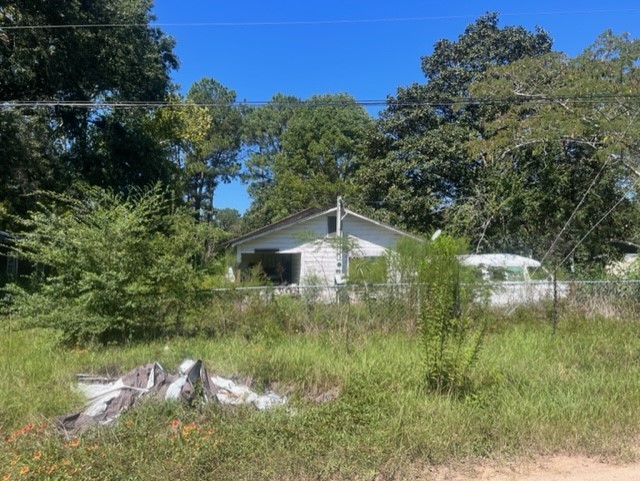 1304 Railroad Avenue Shepherd, TX 77371 - Photo 1 of 5 a view of a lake with a house in the background