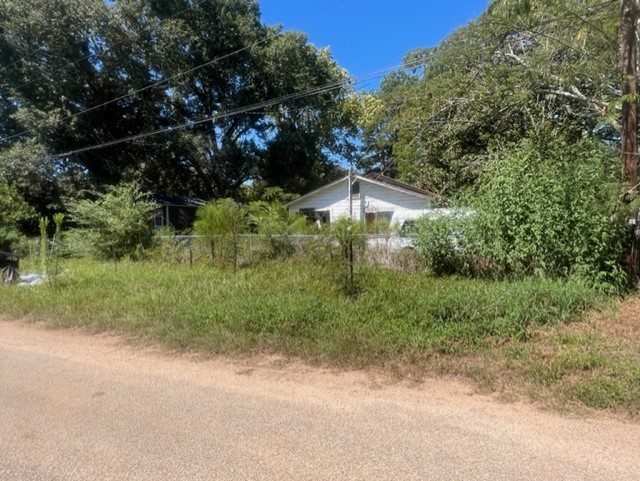 1304 Railroad Avenue Shepherd, TX 77371 - Photo 5 of 5 a backyard of a house with lots of green space