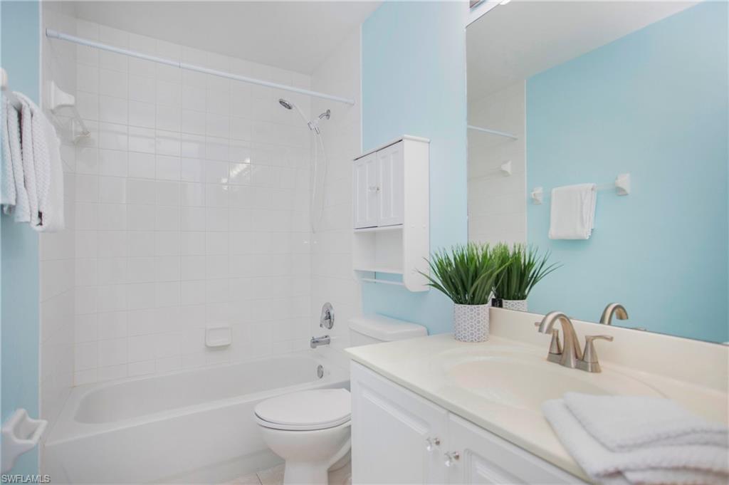 21722 Windham Run Estero, FL 33928 - Photo 19 of 40 a bathroom with a sink a toilet a tub and shower