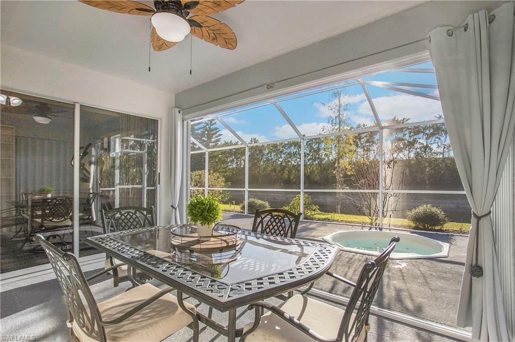 21722 Windham Run Estero, FL 33928 - Photo 23 of 40 a dining room with furniture a chandelier and wooden floor