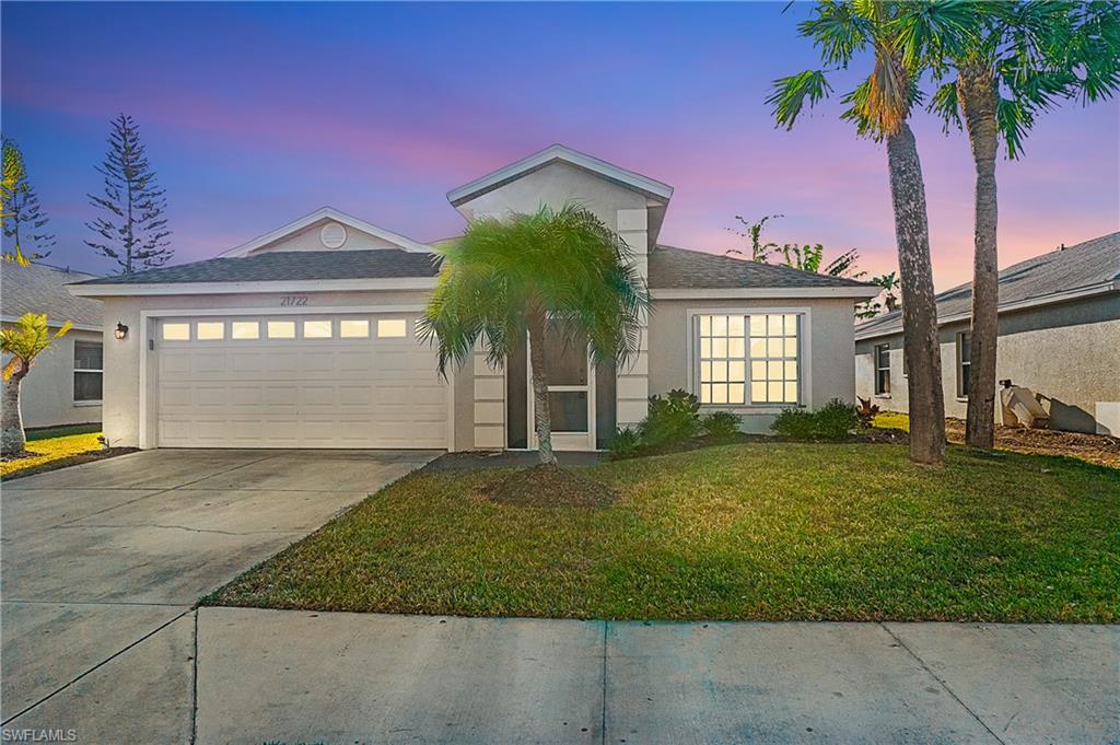 21722 Windham Run Estero, FL 33928 - Photo 31 of 40 a front view of a house with garden