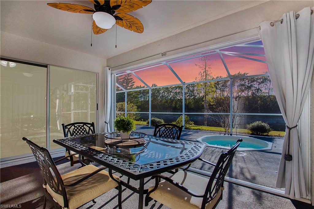 21722 Windham Run Estero, FL 33928 - Photo 32 of 40 a view of a dining room with furniture wooden floor and chandelier