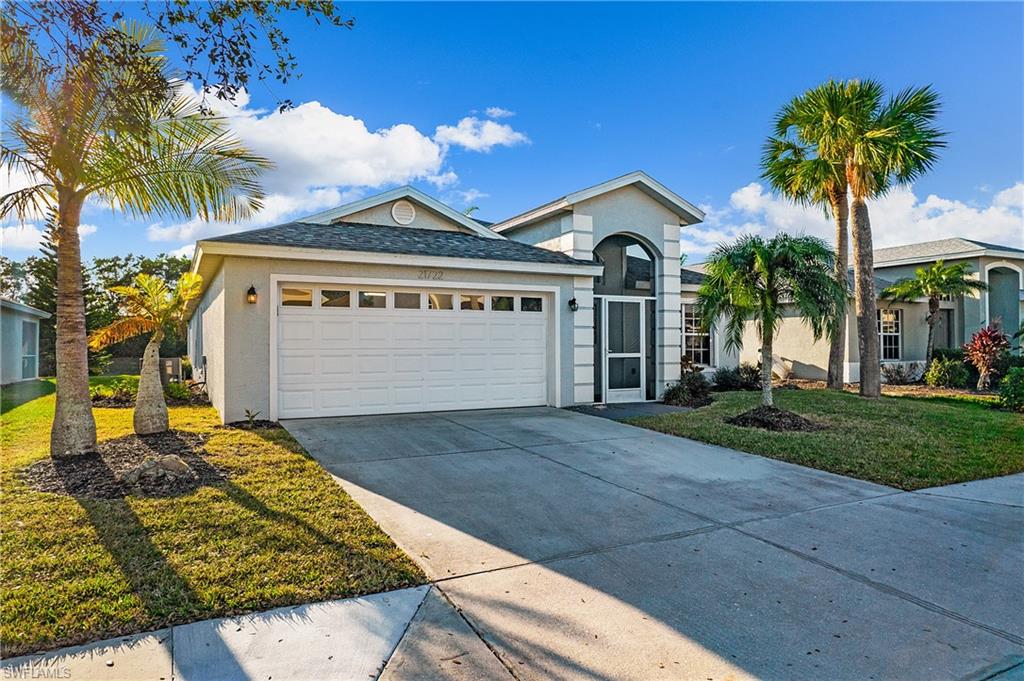 21722 Windham Run Estero, FL 33928 - Photo 6 of 40 a front view of a house with a yard and garage