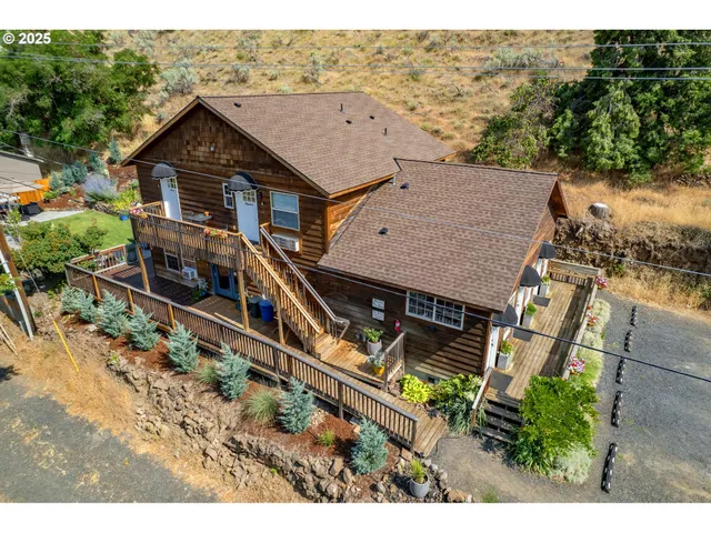 an aerial view of a house with a yard and balcony