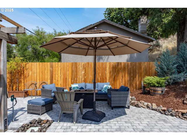 a view of a outdoor sitting area with furniture and umbrella
