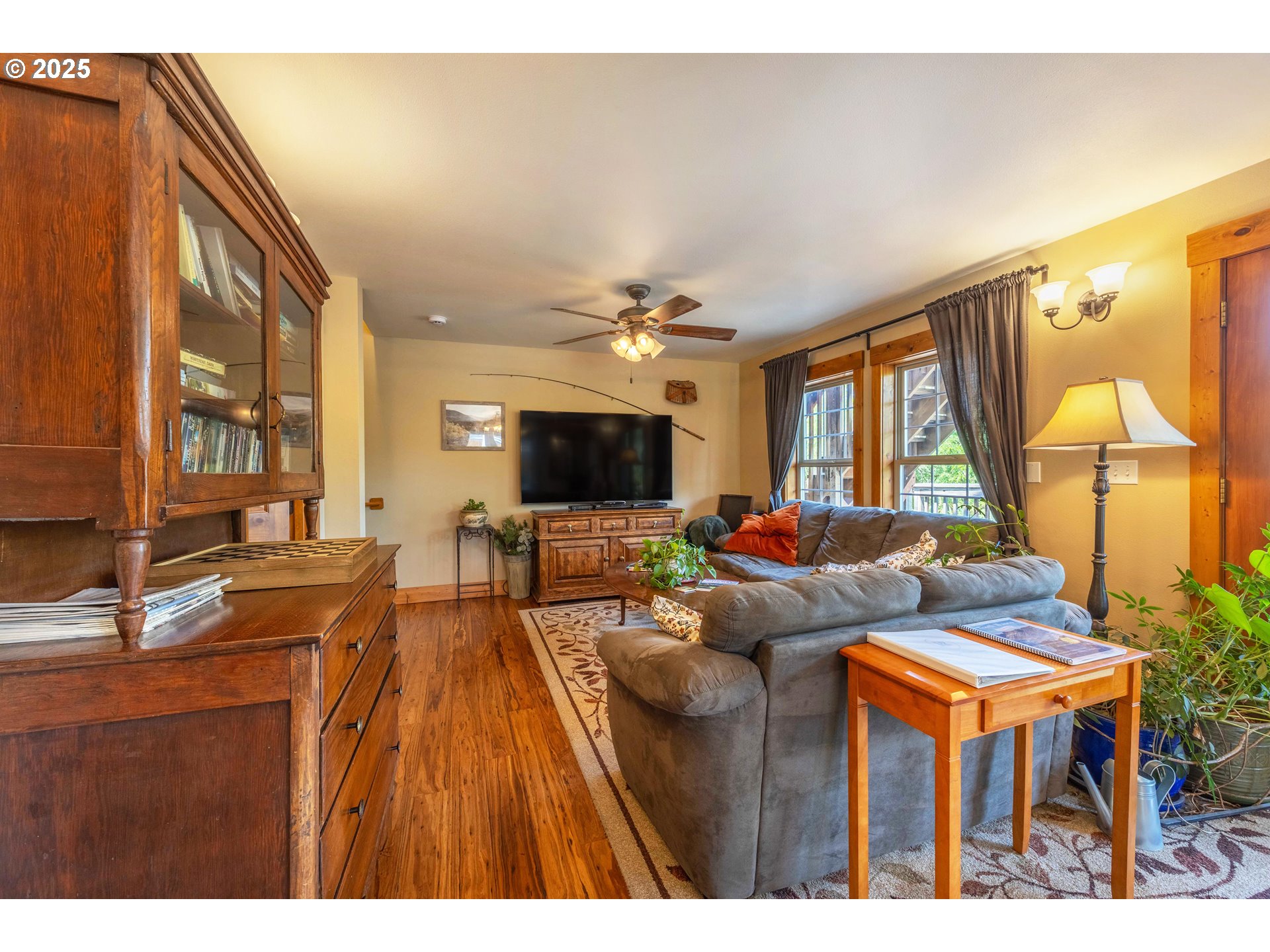 210 Hartman Avenue Maupin, OR 97037 - Photo 28 of 46 a living room with furniture a chandelier and a flat screen tv