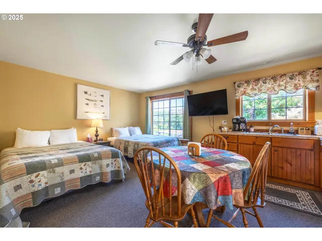 a bedroom with two beds and a large window