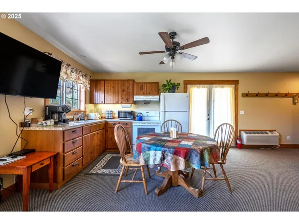 a view of a dining room with furniture and a kitchen