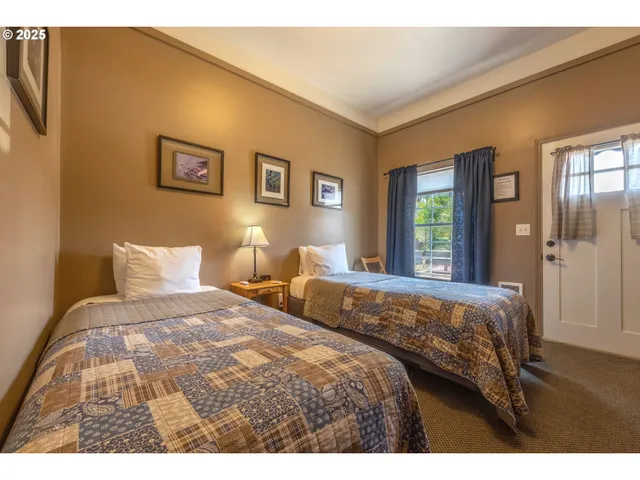 a bedroom with two beds and a window