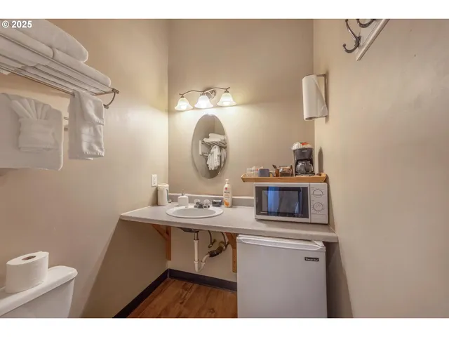 a kitchen with a sink cabinets and a mirror