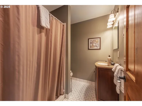 a bathroom with a sink mirror and vanity