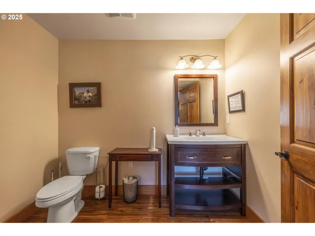 a bathroom with a toilet a sink and mirror