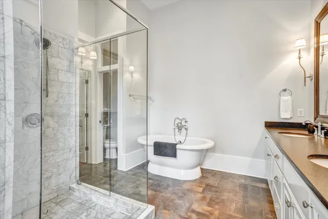 a spacious bathroom with a shower toilet and sink