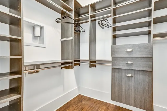 a view of walk in closet with empty racks