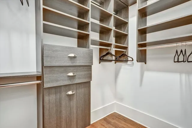 a view of walk in closet with empty racks