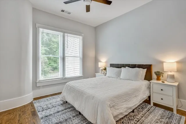 a bedroom with a large bed and a window