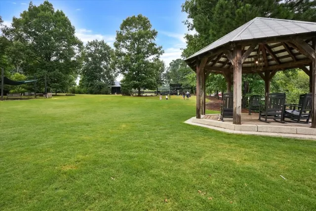 a view of a patio with a table chairs and a yard