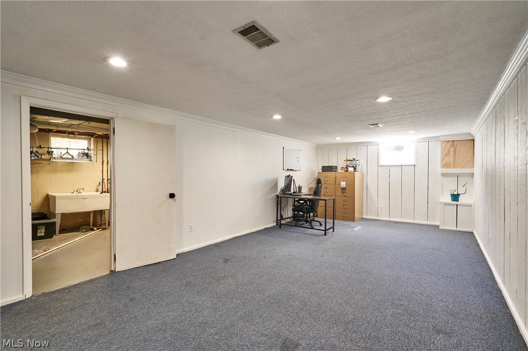 1535 Belle Meade Drive Akron, OH 44321 - Photo 25 of 33 Spacious recreation room featuring updated canned lighting, neutral paint, and carpeting.