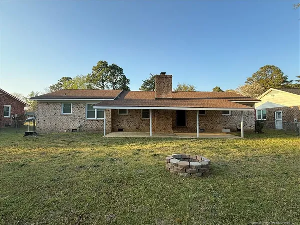 a front view of a house with a garden and yard