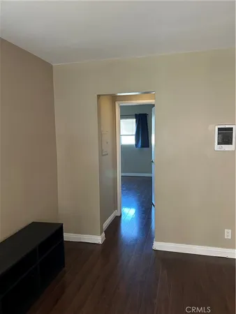 a view of a livingroom with wooden floor and closet