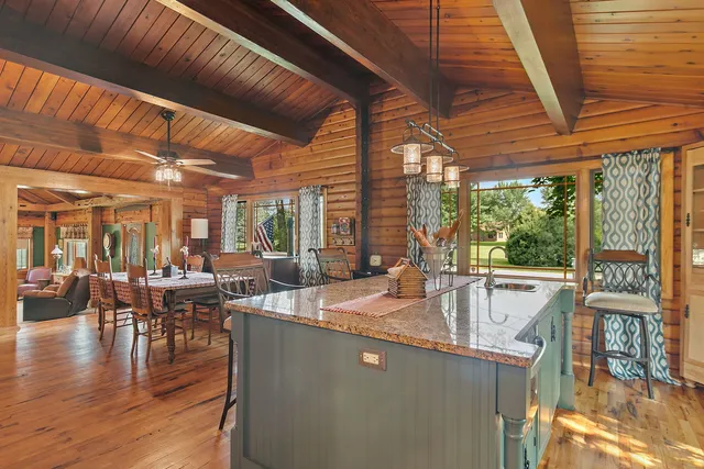 a dining room with furniture and wooden floor